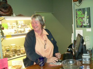 Christine Nanney behind the counter at Mind Body Spirit dispensary.