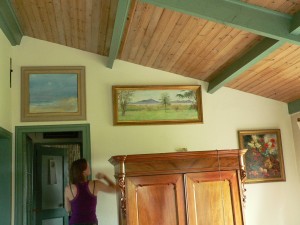 Girl adjusting paintins inside of old house in The Netherlands