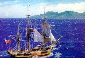 Idealized picture of recreation of HMS BOunty sailing on cobalt blue seas