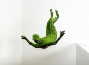 man made of grass falling upside down