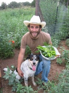 Too High to Fail author Doug Fine, his dog, and a bowl of fresh veggies from his garden