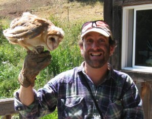 Too High to Fail author Doug Fine holding an owl