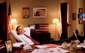 Obama in his office with pictures of Lincoln and MLK
