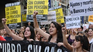 Unemployed Spanish women protest banks at an economic summit