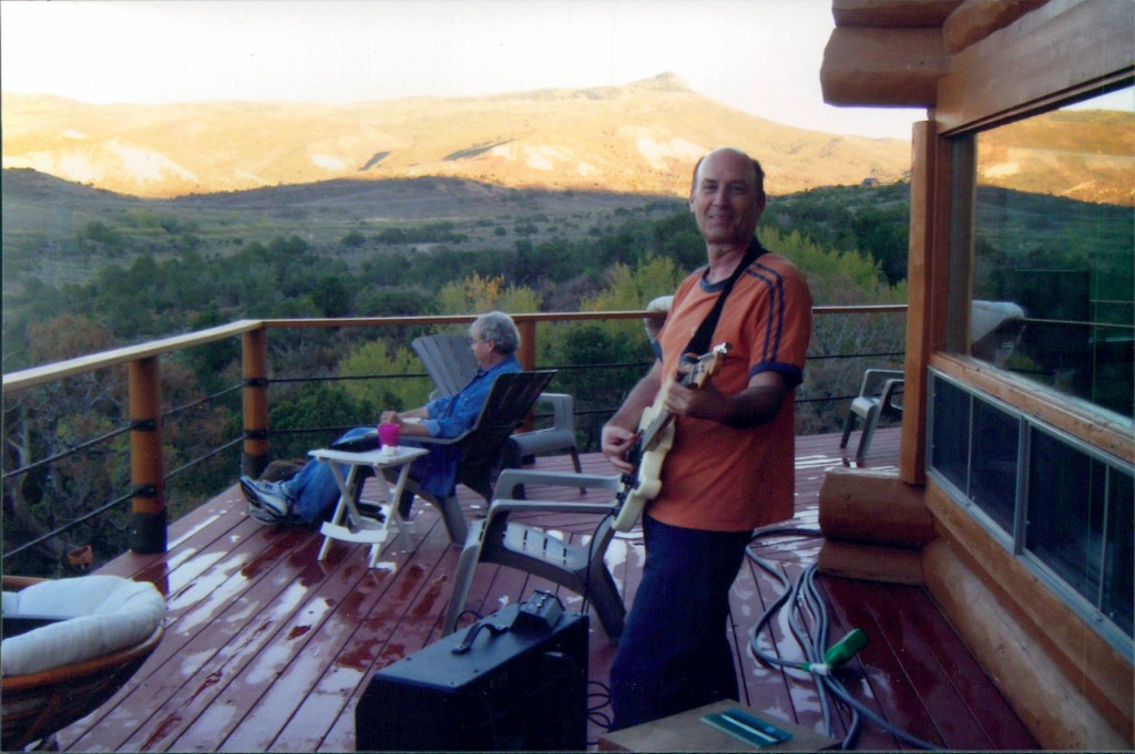 Lory Kohn playing a stratocaster on the deck outside Paonia, Colorado