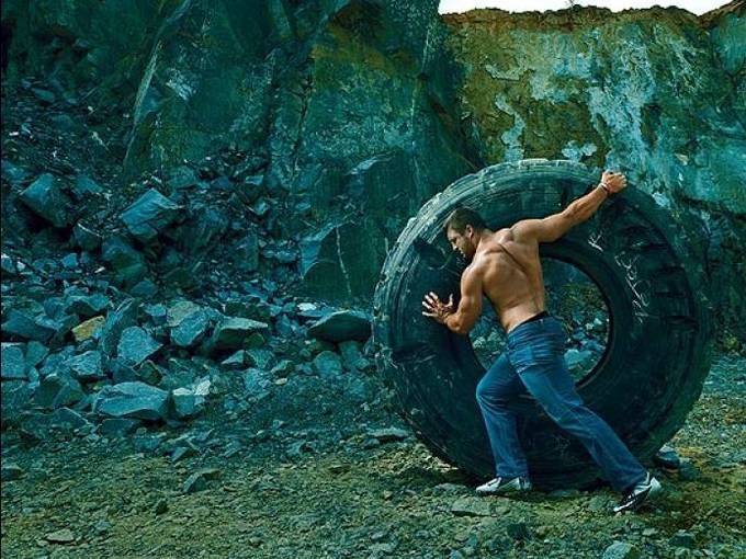 tim tebow rolling a giant tire 
