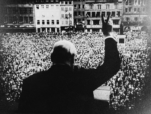 Winston Churchill gives an adoring crowd the "V" for victory sign