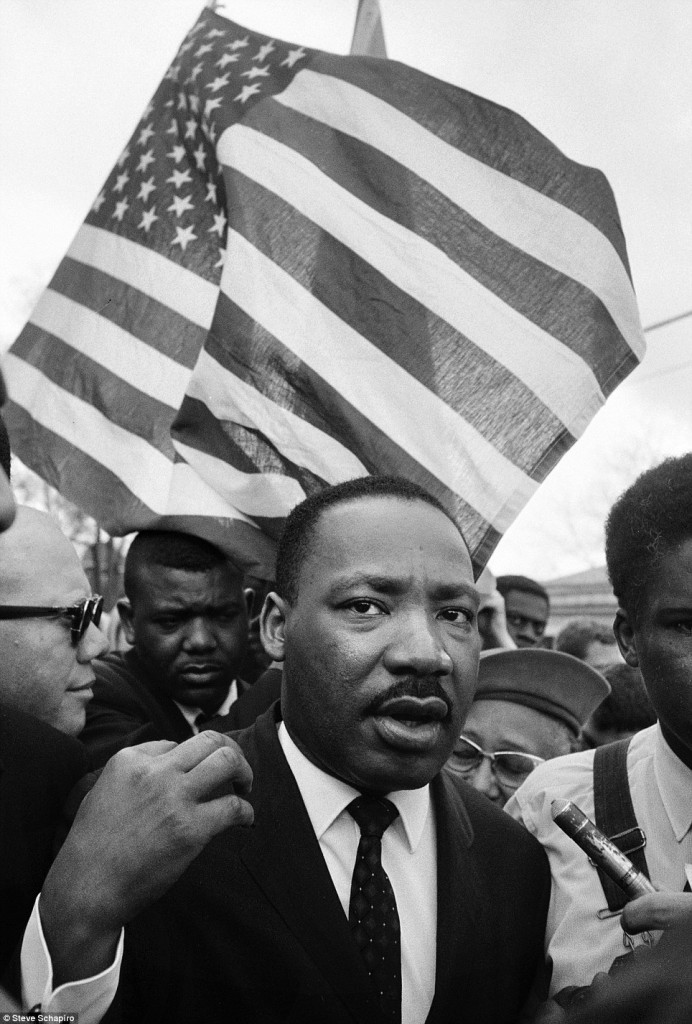 martin luther king in front of a huge American flag