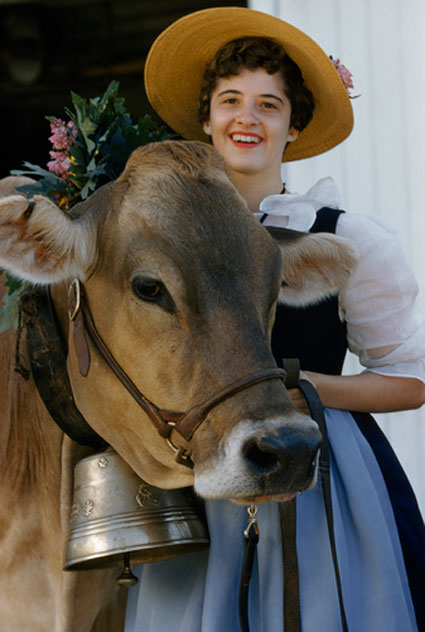 old fashoned milkmaid with prize cow